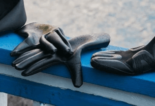 Vissla Neoprene Gloves on a Railing from the Peer