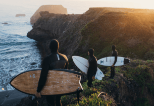Surfers on a cliff with Vissla neoprene bonnets